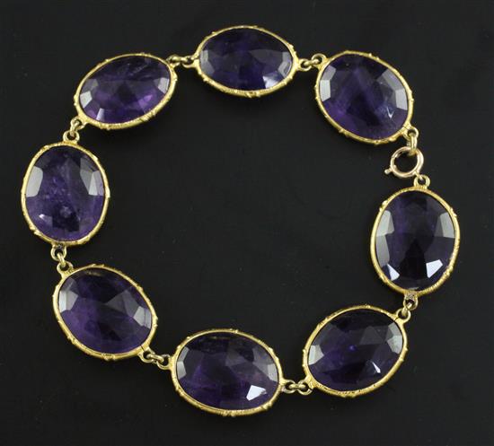 A gold and amethyst bracelet, approx 7.5in.
